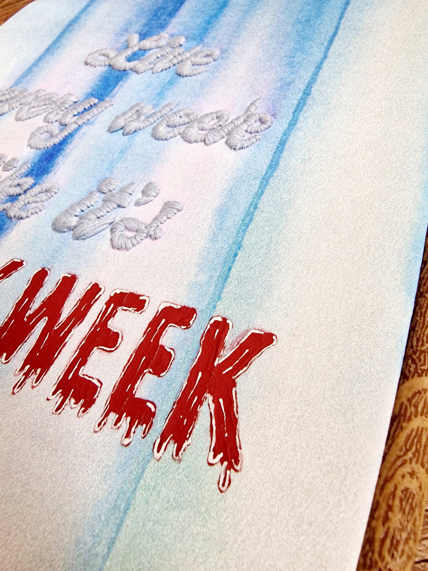 Hand embroidery detail on digitally printed silk - Shark Week menstrual humor hoop